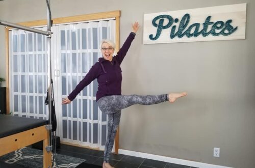 Be a leader, be you. Playful pose in front of Pilates sign