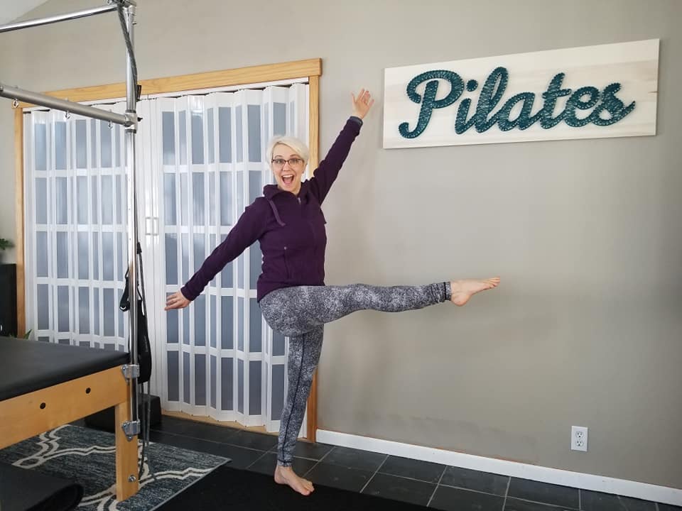 Be a leader, be you. Playful pose in front of Pilates sign