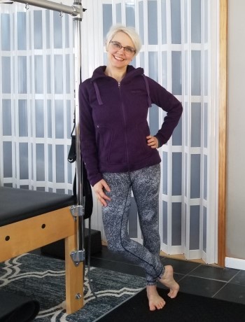 Ginny Massie standing by Pilates Trap Table